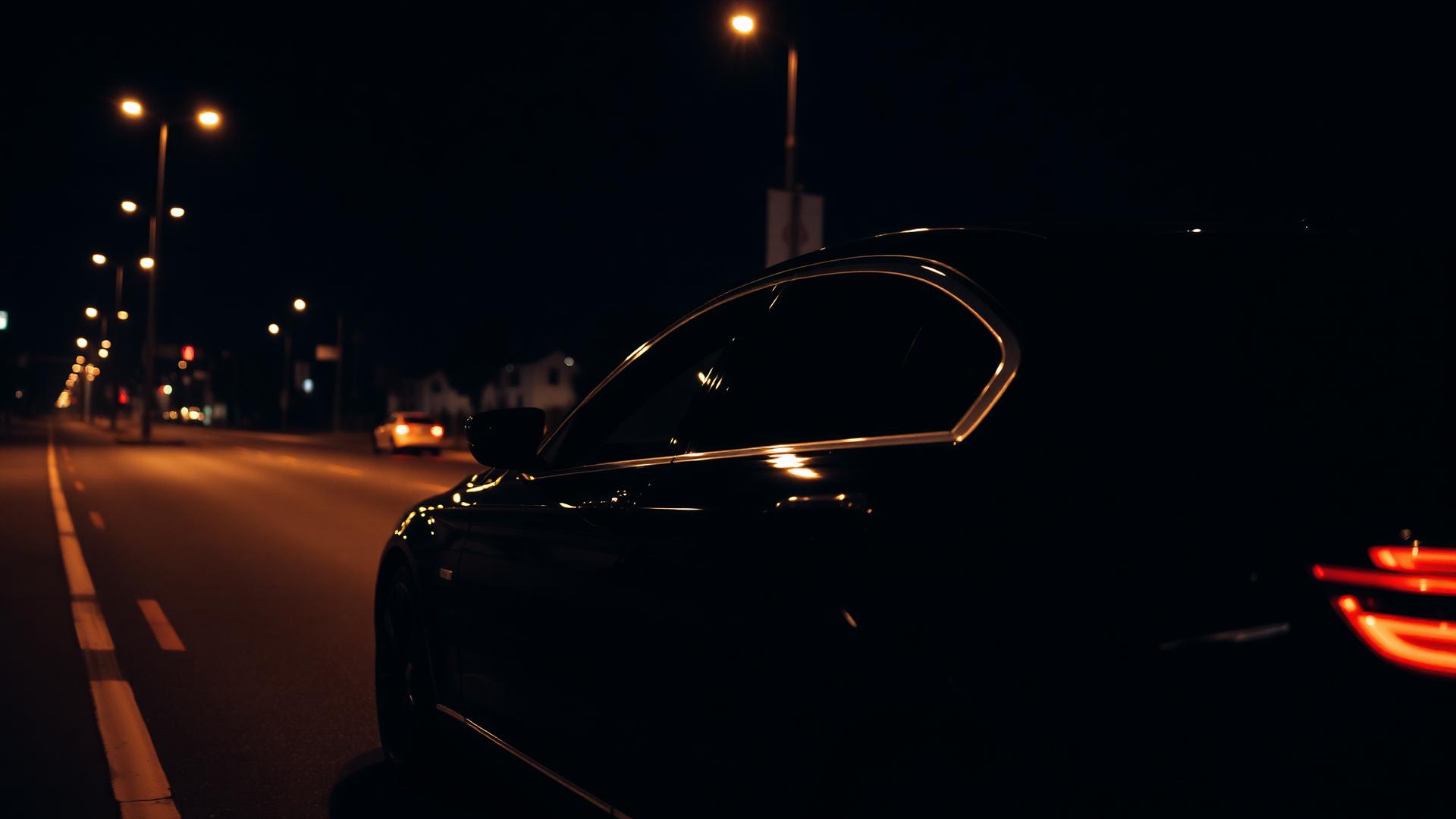 Black luxury sedan at night